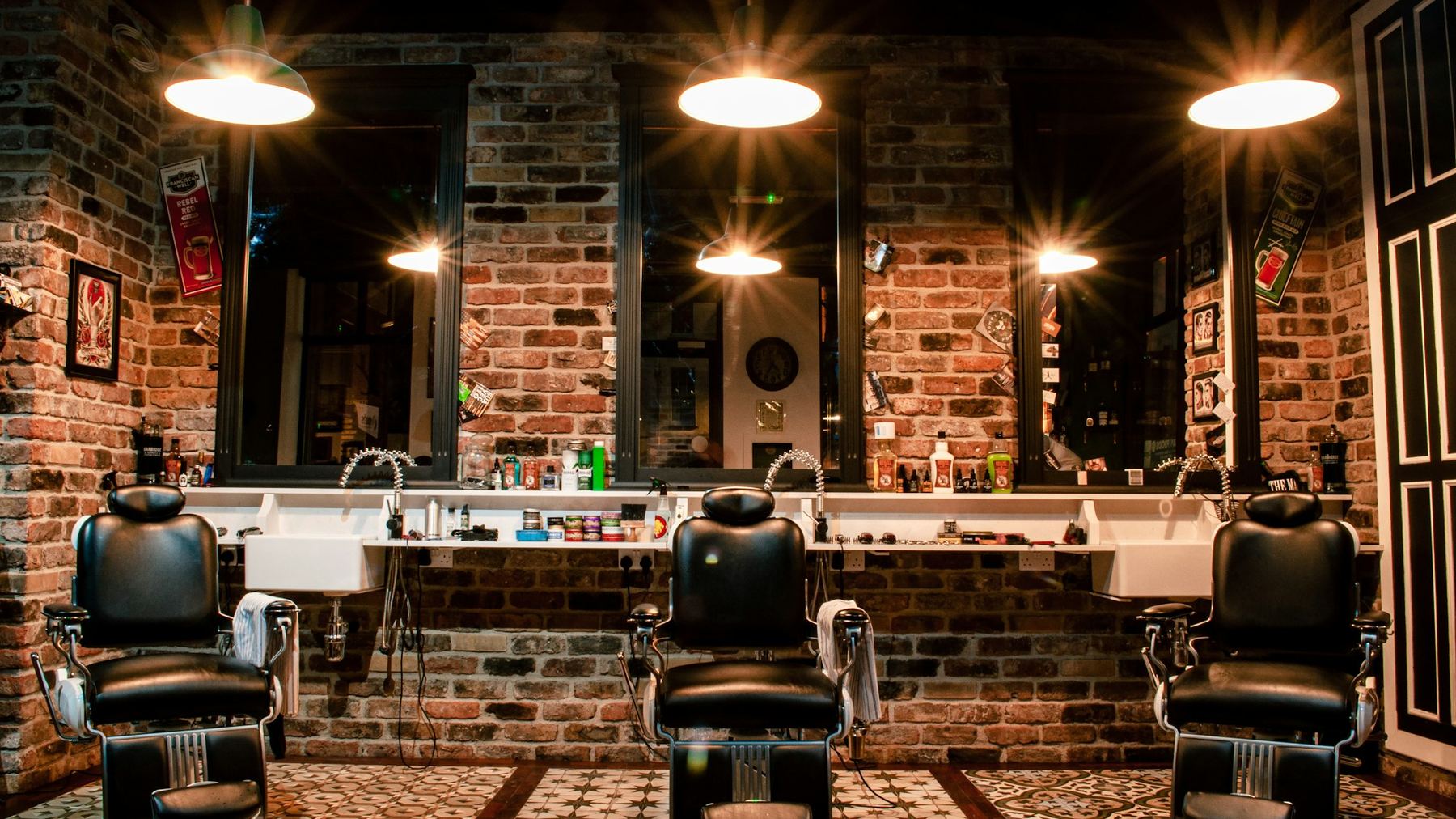The inside of a barbershop, chairs along a mirrored wall
