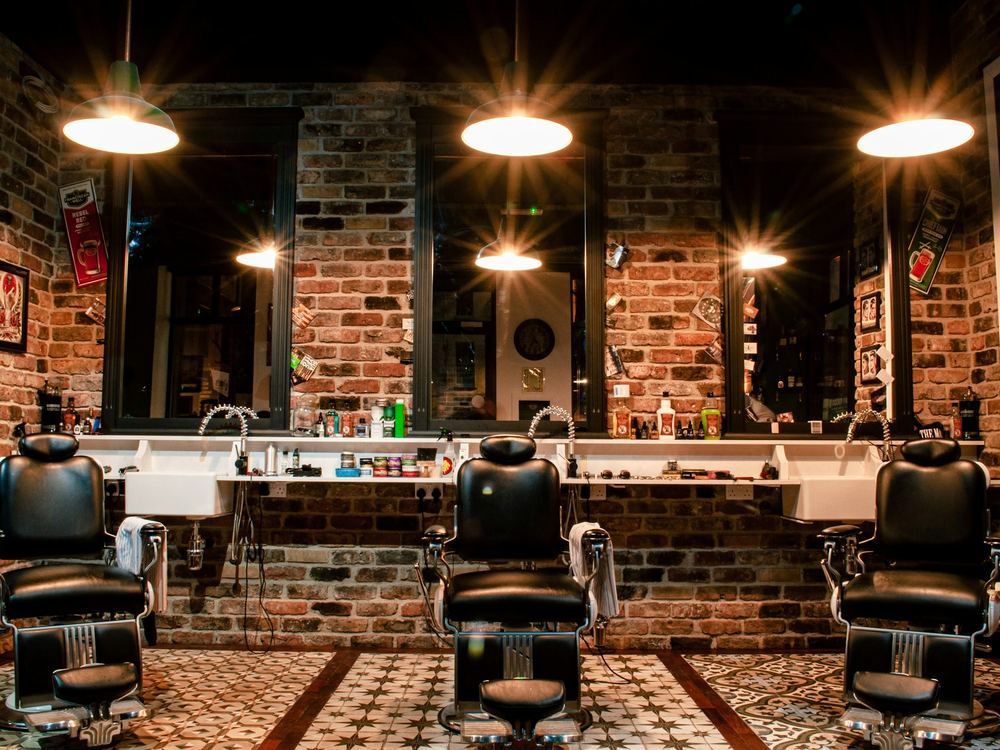 The length of the shop, chairs along a mirrored wall
